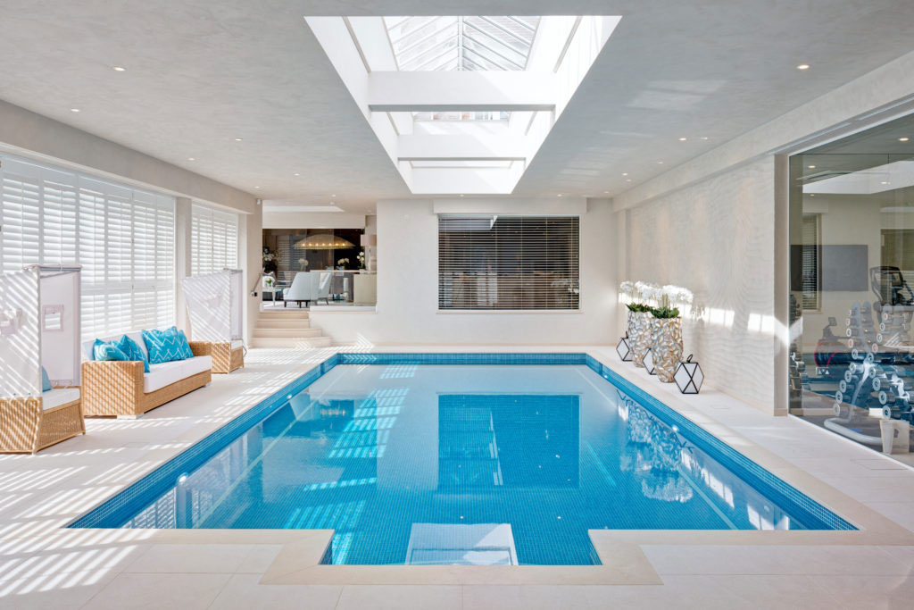 Indoor swimming pool for residential home in Surrey by Hill House Interiors