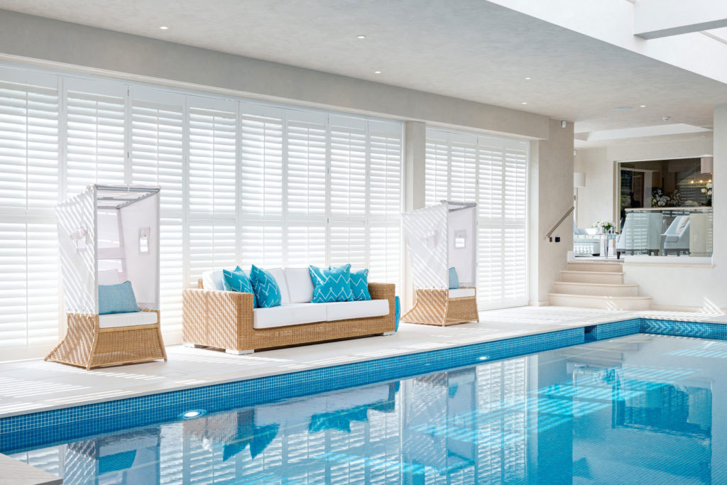 Interior design for indoor swimming pool in residential home in Surrey by Hill House Interiors