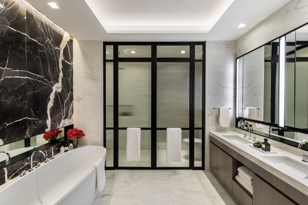 Bathroom design with black marble wall feature and double sink vanity unit