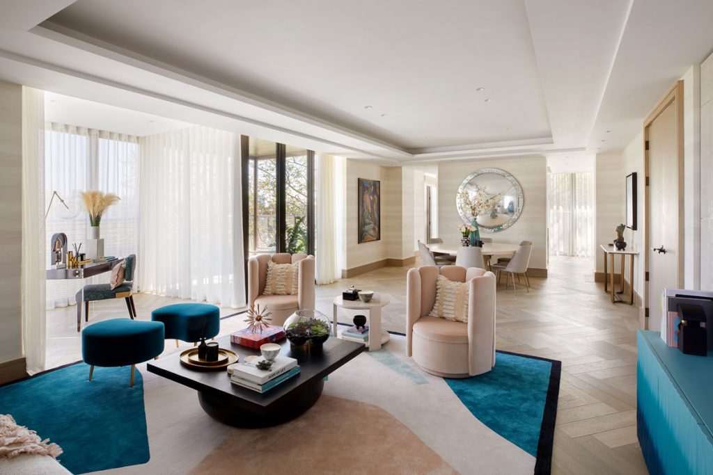 Open plan living area with light wood floor and statement rug