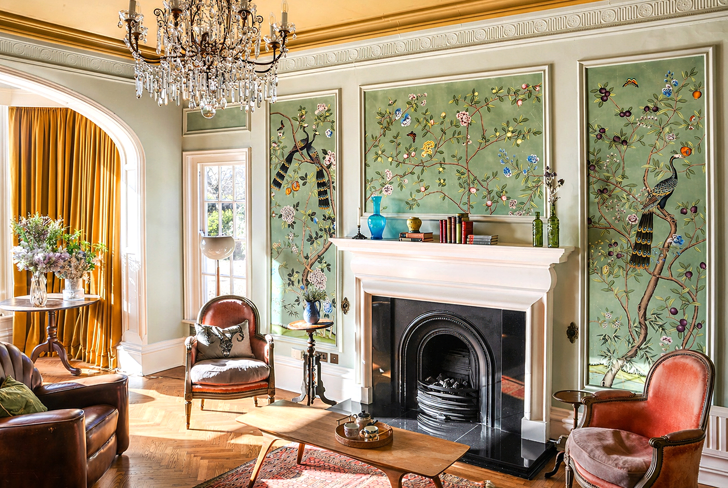 Elegant period living room with fireplace, botanical murals and antique furniture